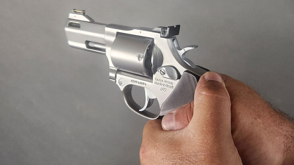 How to Operate a Revolver: Next, wrap your non-dominant hand around the dominant hand, ensuring that the fingers lay on top of the dominant hand.