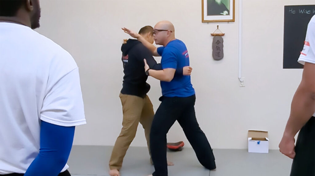 Patrick Vuong (right) of Tiga Tactics demonstrates how, after protecting yourself from the initial attack, it’s time to reposition yourself so that you can go on the offensive.