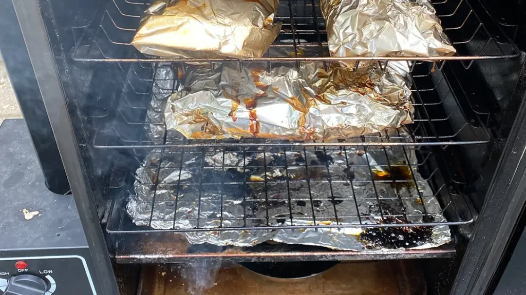 After three hours, wrap the ribs in tin foil and seal the edges. 