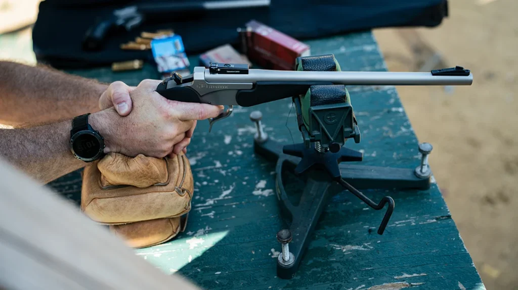 When shooting a hand cannon from a hard bench, a sandbag under the grip keeps the handgun steady, making longer shots more successful.