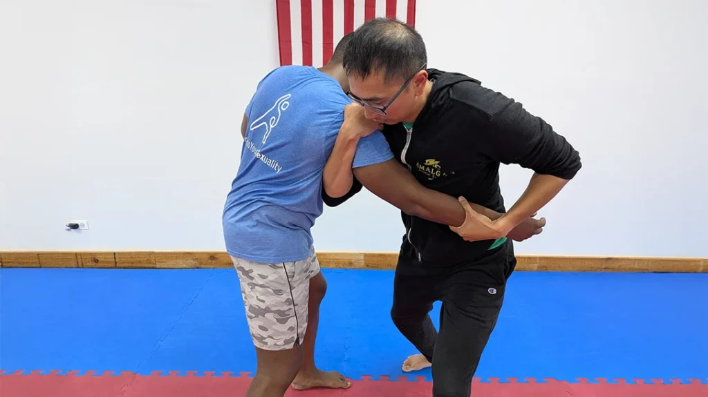 While applying wrist control, Adam steps in and applies an underhook to Brian’s shoulder.