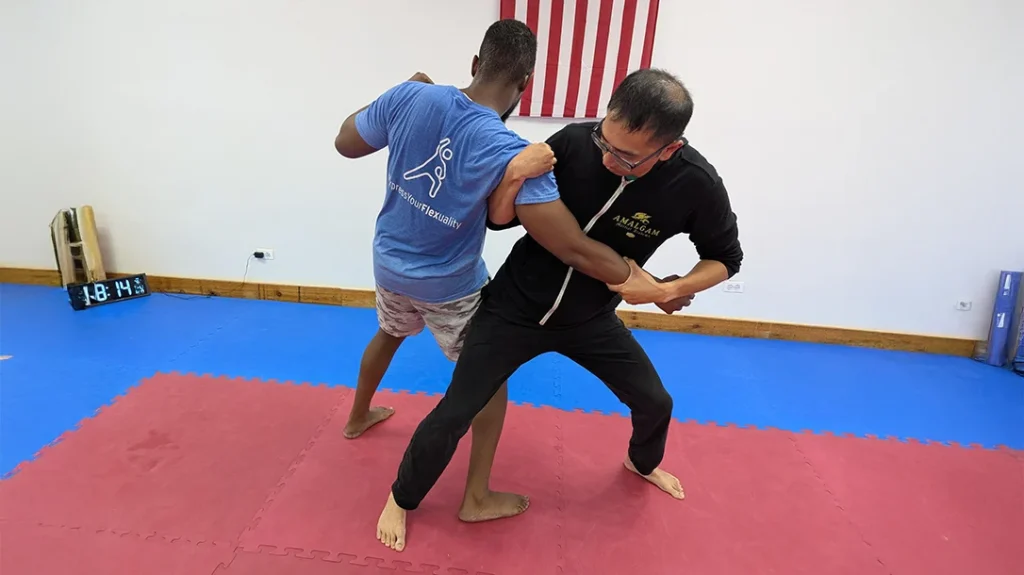 Adam steps through behind Brian and drives his hip under Brian’s.