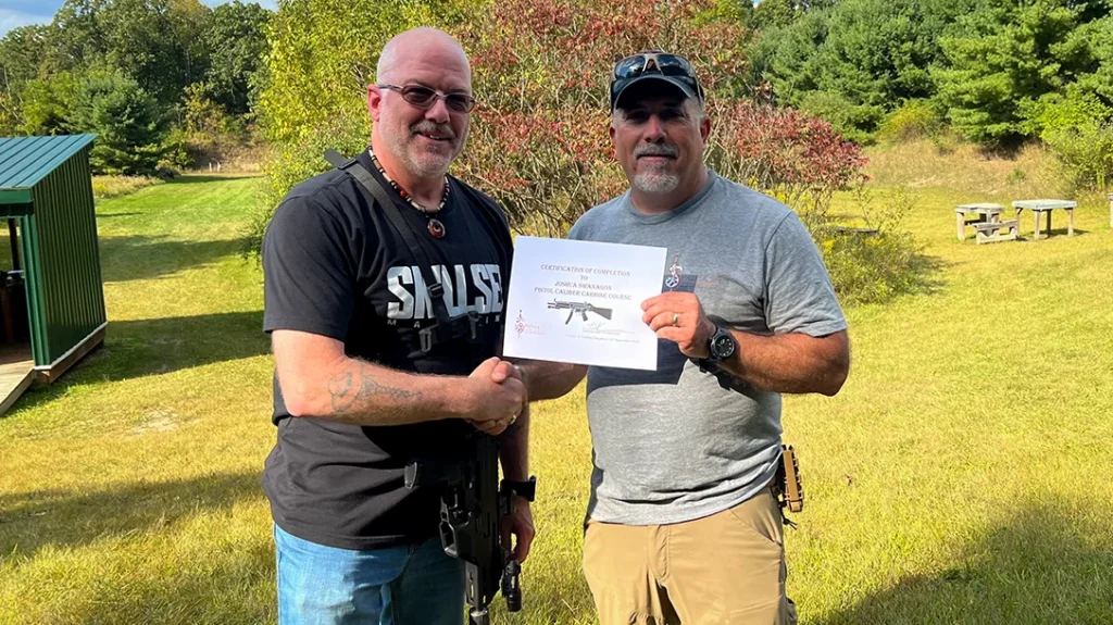 The author being presented with his certificate of completion by Tom Alibrando of Spatha Training & Consulting.