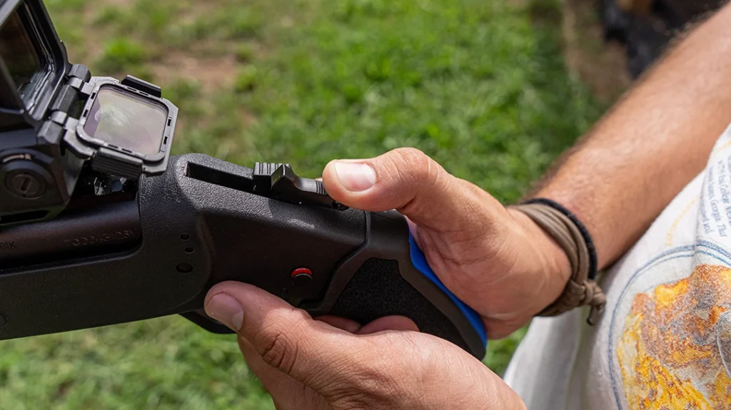 With the safety off and the trigger pulled back, the hammer face contacts the transfer bar, which strikes the firing pin and discharges the round.