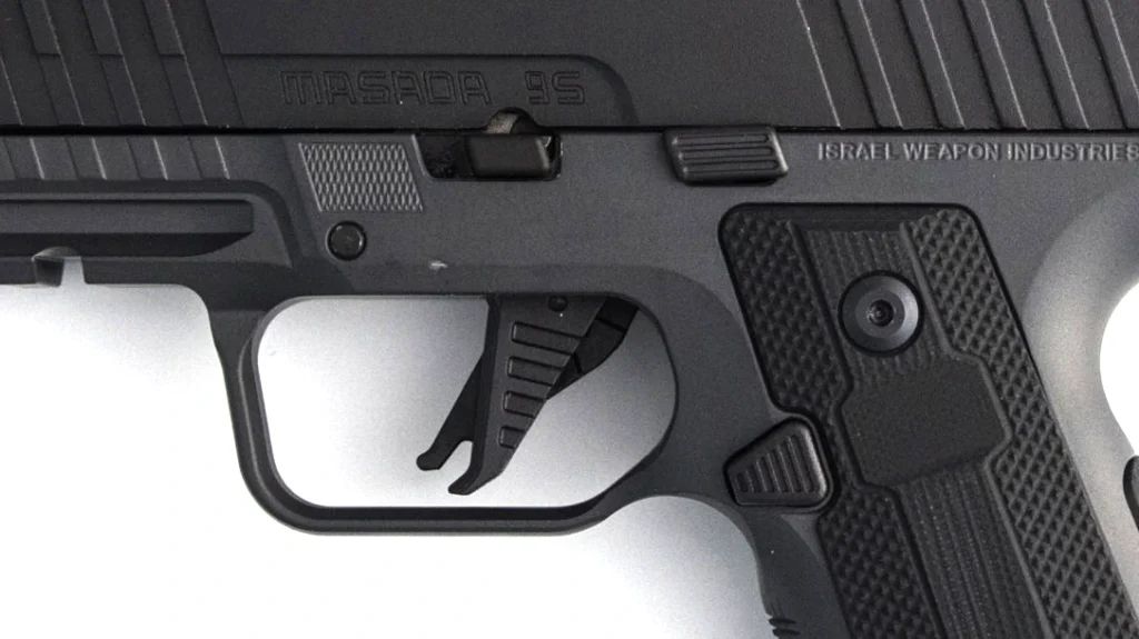 The flat trigger from the original IWI Masada Slim is still used on the Masada Slim Commander Elite pistol.