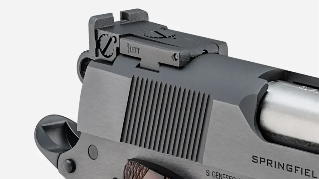 The rear sight’s elevation and windage adjustments can be found on the top and side of the rear sight.
